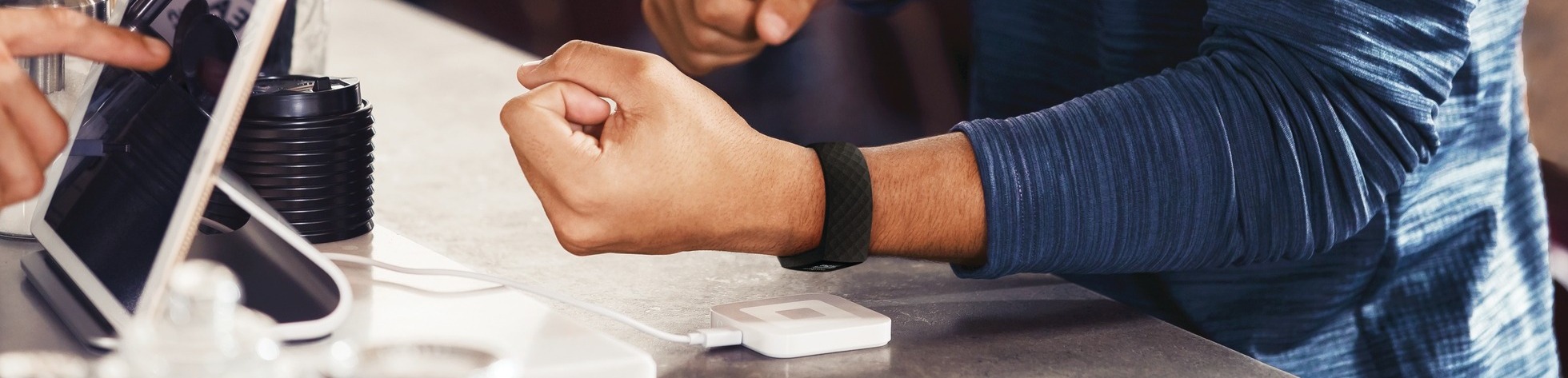 Man holding smart watch near card reader