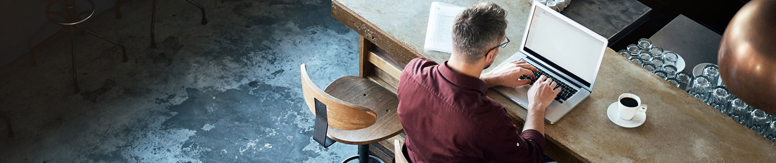 Man using laptop at counter