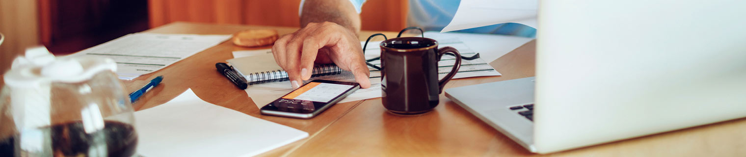 Man typing on phone calculator