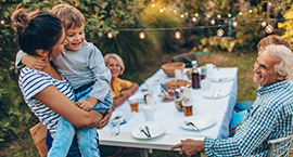 Family in backyard dining.