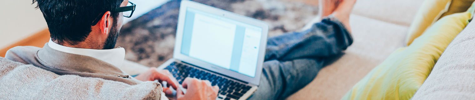 Man using laptop on couch